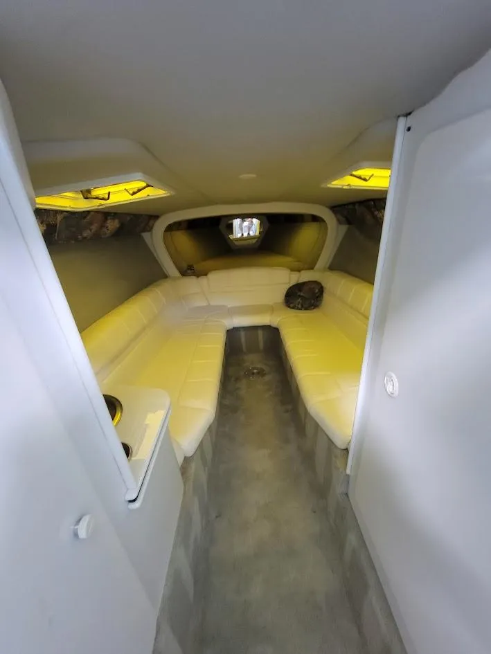 Slide: The Image of 1998 Formula 353 FASTech boat interior with white seating and modern design. - 7