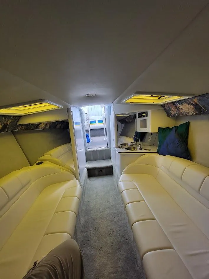 Slide: The Image of Interior of 1998 Formula 353 FASTech boat with white leather seating and modern amenities. - 8