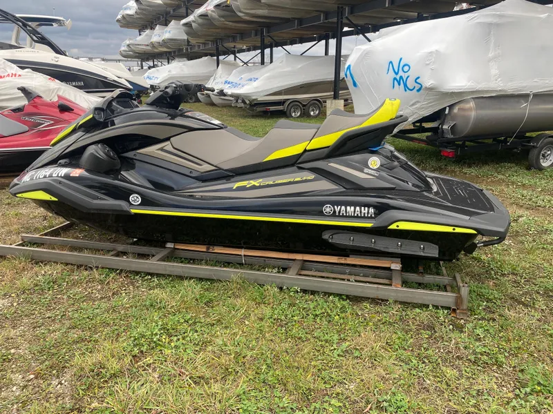 Slide: The Image of 2023 Yamaha WaveRunner FX Cruiser SVHO in storage, sleek black and yellow design. - 7