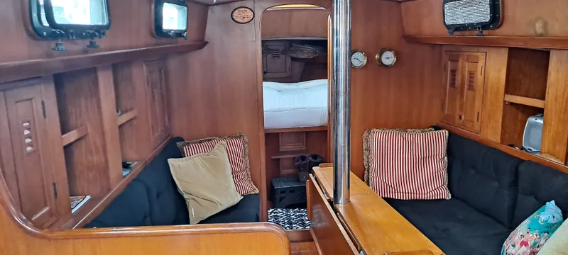 Slide: The Image of Interior of 1985 Cheoy Lee Pedrick 38w sailboat with wood finish and cozy seating. - 4