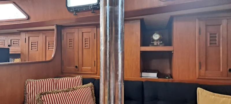 Slide: The Image of Interior of 1985 Cheoy Lee Pedrick 38w yacht with wooden cabinetry and striped cushions. - 5