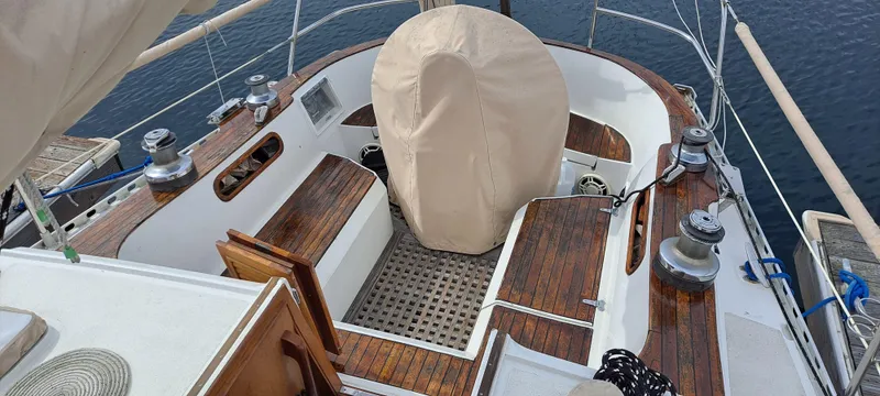 Slide: The Image of 1985 Cheoy Lee Pedrick 38w sailboat cockpit with wooden accents and covered steering wheel. - 8