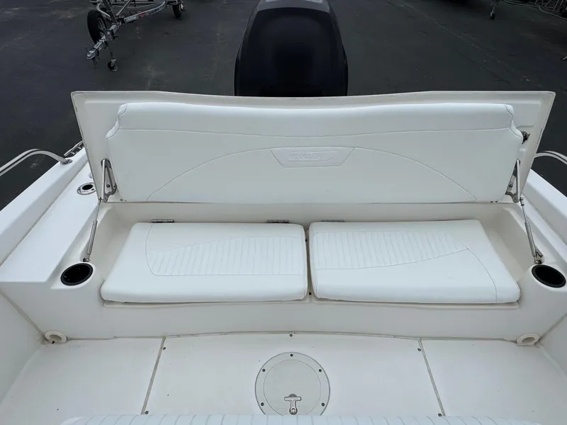 Slide: The Image of 2008 Boston Whaler 200 Dauntless boat seating area with white cushions and cup holders. - 11
