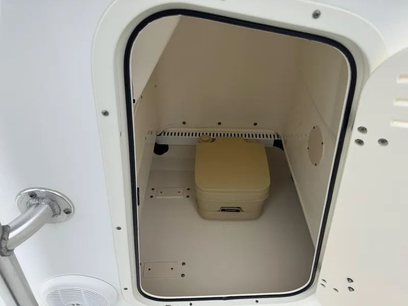 Slide: The Image of Storage compartment with portable toilet in 2008 Boston Whaler 200 Dauntless boat. - 12