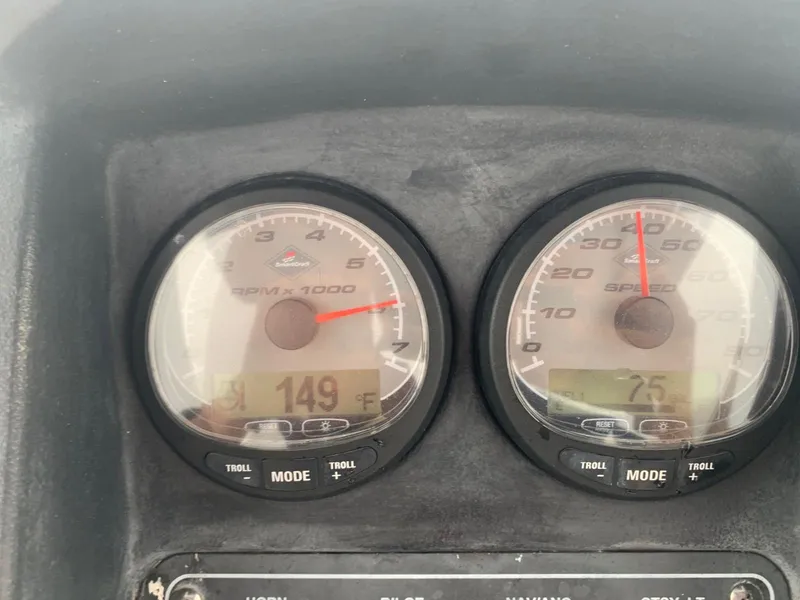 Slide: The Image of Dashboard gauges of a 2008 Boston Whaler 200 Dauntless boat showing RPM and speed. - 14