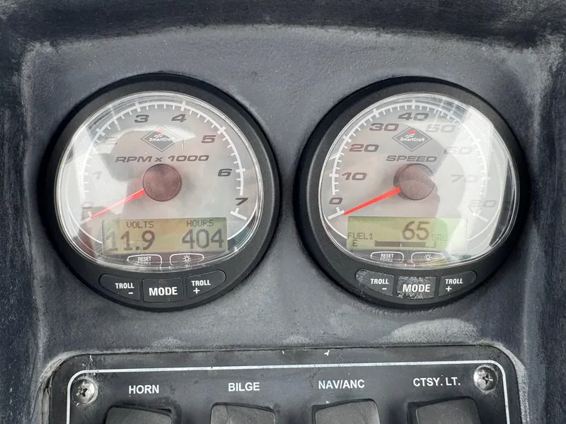 Slide: The Image of Dashboard of a 2008 Boston Whaler 200 Dauntless showing RPM and speed gauges. - 15
