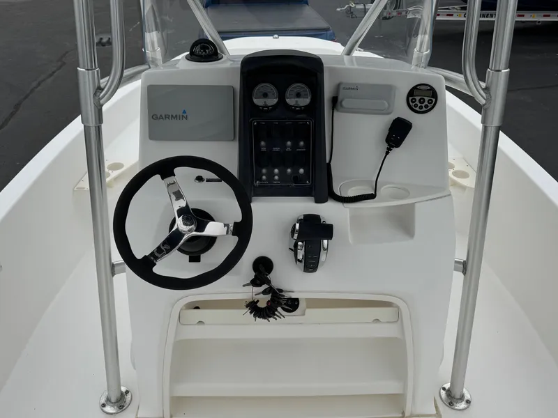 Slide: The Image of 2008 Boston Whaler 200 Dauntless boat console with steering wheel and Garmin navigation system. - 8