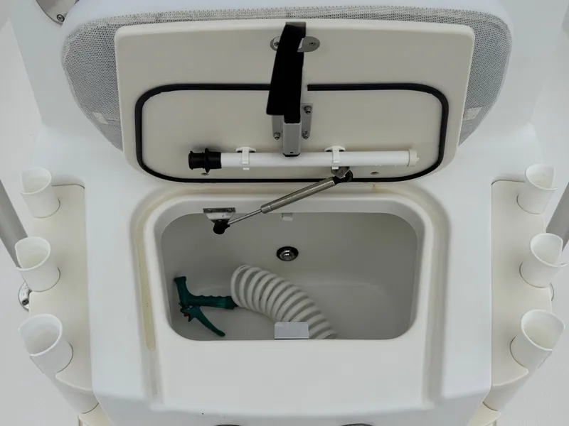 Slide: The Image of Boston Whaler 2008 Dauntless 200 boat storage compartment with hose and rod holders. - 9