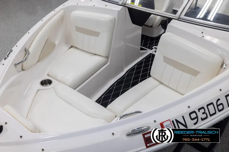 Slide: The Image of 2008 Regal 1900 boat interior with white seating and black flooring. - 11