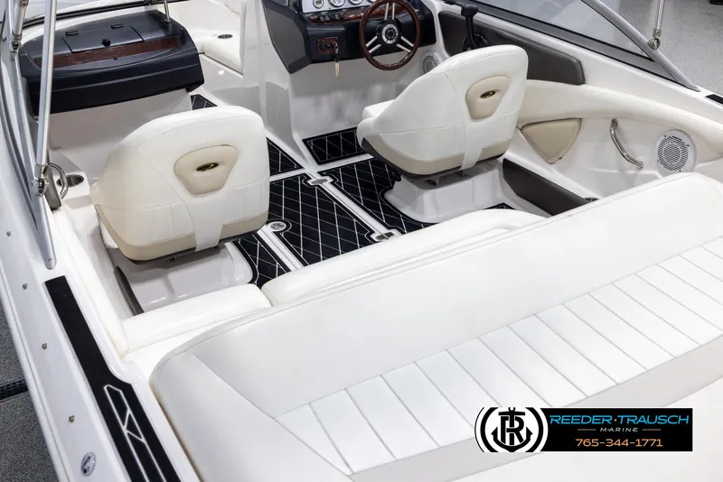 Slide: The Image of Interior of a 2008 Regal 1900 boat with white seating and dashboard. - 12