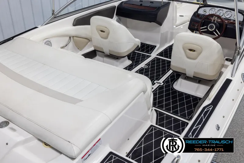 Slide: The Image of Interior of a 2008 Regal 1900 boat with white seating and black flooring. - 13
