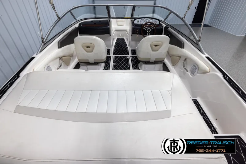 Slide: The Image of 2008 Regal 1900 boat interior with white seating and dashboard. - 14