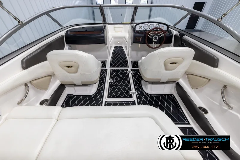 Slide: The Image of Interior of a 2008 Regal 1900 boat with white seating and black flooring. - 15
