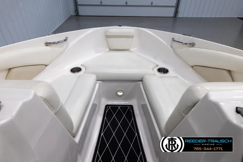 Slide: The Image of 2008 Regal 1900 boat interior with white seating and cup holders. - 17