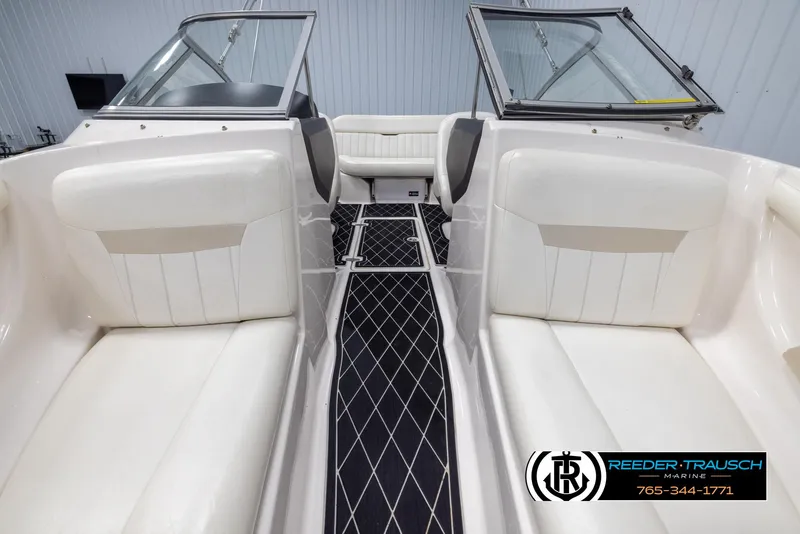 Slide: The Image of Interior of 2008 Regal 1900 boat with white seating and black diamond-patterned flooring. - 18