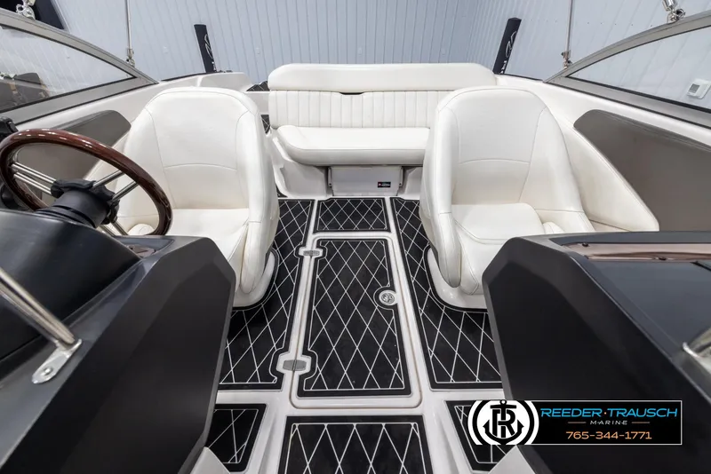 Slide: The Image of Interior of a 2008 Regal 1900 boat with white seating and black diamond-patterned flooring. - 19