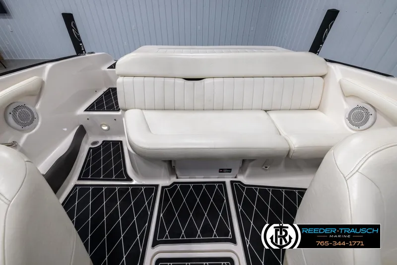 Slide: The Image of 2008 Regal 1900 boat interior with white seating and black diamond-patterned flooring. - 20