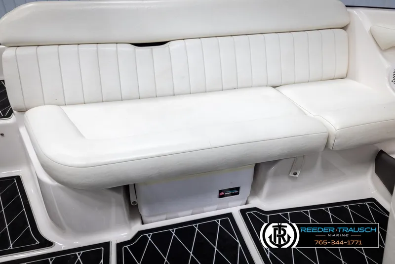Slide: The Image of 2008 Regal 1900 boat interior with white seating and black flooring. - 23