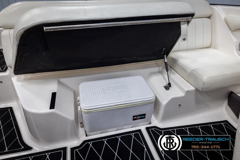 Slide: The Image of 2008 Regal 1900 boat interior with seating and cooler storage. - 24