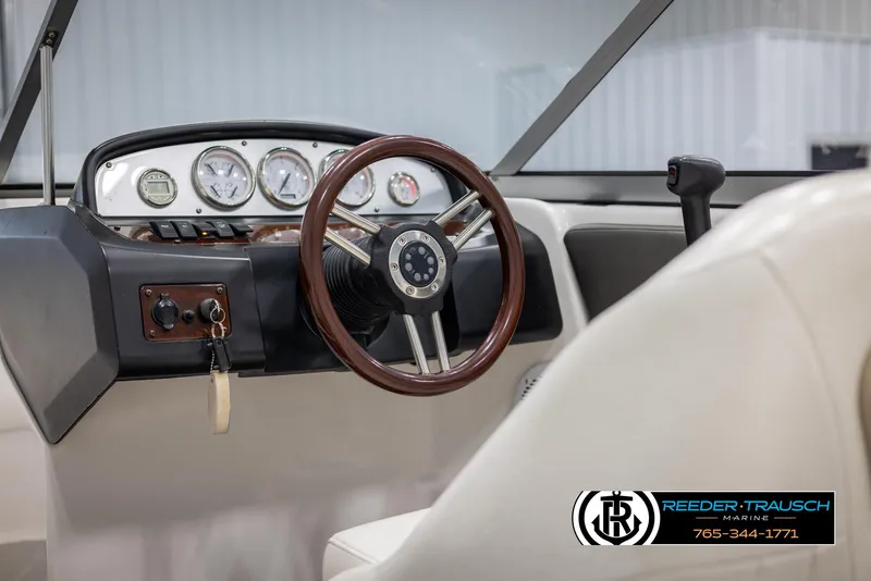 Slide: The Image of 2008 Regal 1900 boat dashboard with steering wheel and gauges. - 26