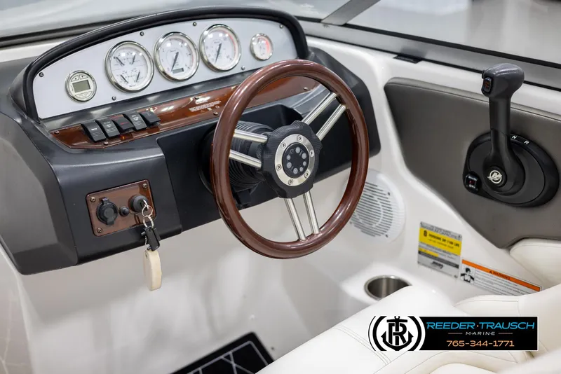 Slide: The Image of 2008 Regal 1900 boat dashboard with steering wheel and gauges. - 27
