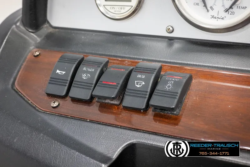 Slide: The Image of Dashboard switches of a 2008 Regal 1900 boat with wood paneling. - 29