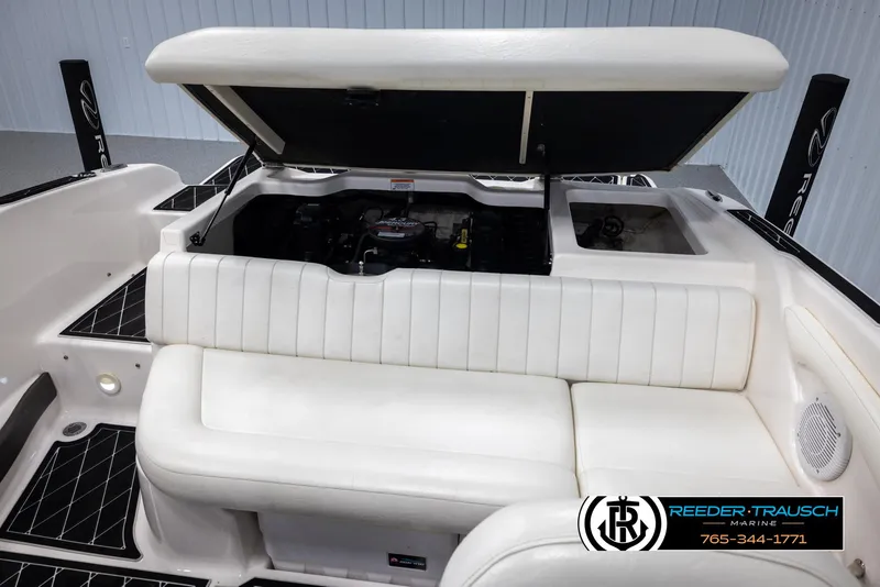Slide: The Image of 2008 Regal 1900 boat interior with open engine compartment, white seating, and logo. - 43