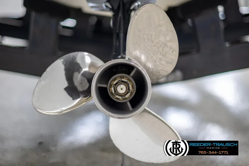 Slide: The Image of Close-up of a 2008 Regal 1900 boat propeller, shiny metal blades. - 48