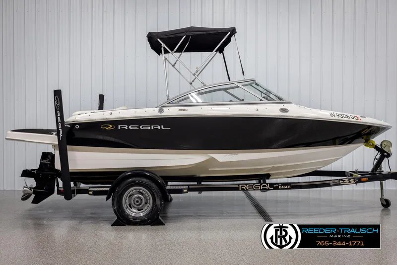 Slide: The Image of 2008 Regal 1900 boat on trailer, black and white design, displayed indoors. - 6