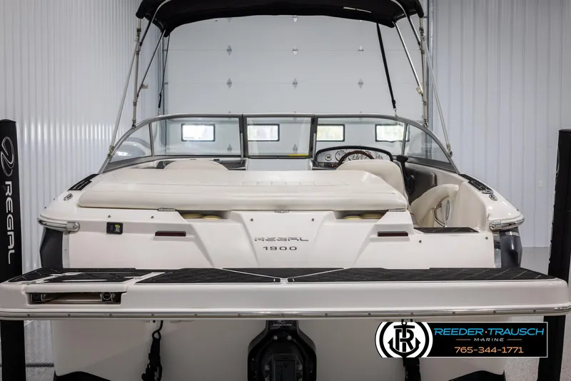 Slide: The Image of 2008 Regal 1900 boat in showroom, rear view with canopy and seating. - 8