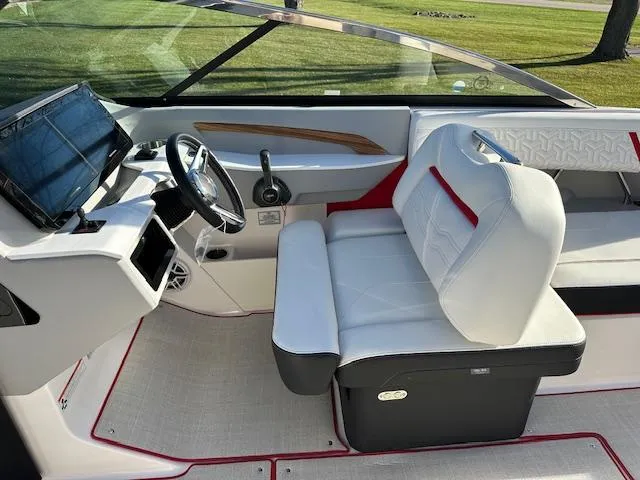 Slide: The Image of 2025 Regal LS9 Surf boat interior with modern dashboard and comfortable seating. - 11
