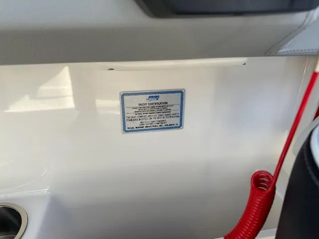 Slide: The Image of 2025 Regal LS9 Surf boat certification label with red safety cord. - 12