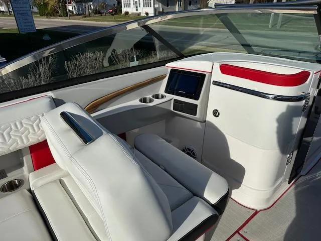 Slide: The Image of 2025 Regal LS9 Surf boat interior with white and red seating, modern dashboard. - 13