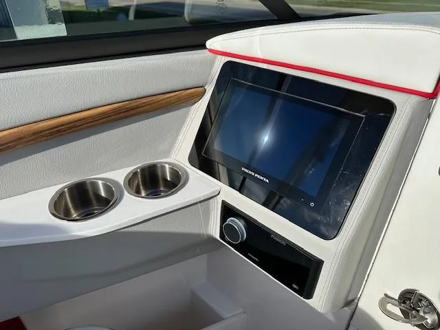 Slide: The Image of 2025 Regal LS9 Surf boat interior with touchscreen and cup holders. - 14