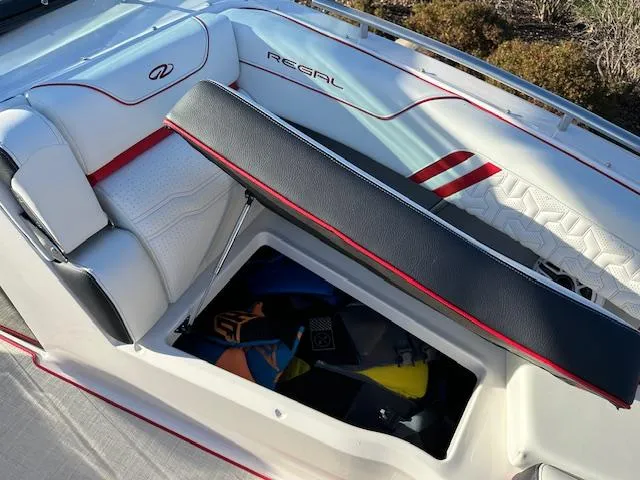 Slide: The Image of 2025 Regal LS9 Surf boat interior with open storage compartment. - 21
