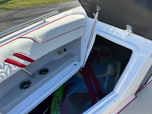 Slide: The Image of 2025 Regal LS9 Surf boat storage compartment with colorful surfboards inside. - 22