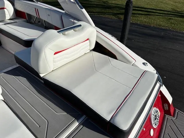 Slide: The Image of 2025 Regal LS9 Surf boat interior with white and red seating. - 29