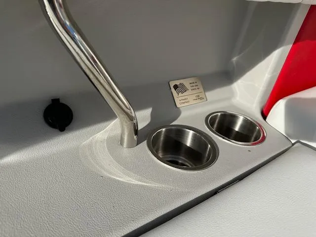 Slide: The Image of 2025 Regal LS9 Surf boat interior with stainless steel cup holders and sleek design. - 31