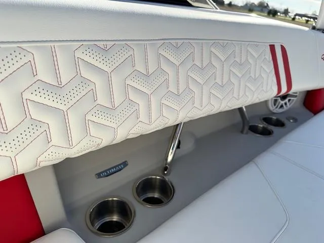 Slide: The Image of 2025 Regal LS9 Surf boat interior with stylish white and red upholstery and cup holders. - 35