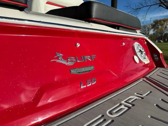 Slide: The Image of 2025 Regal LS9 Surf boat, red exterior, close-up of branding and logo. - 40