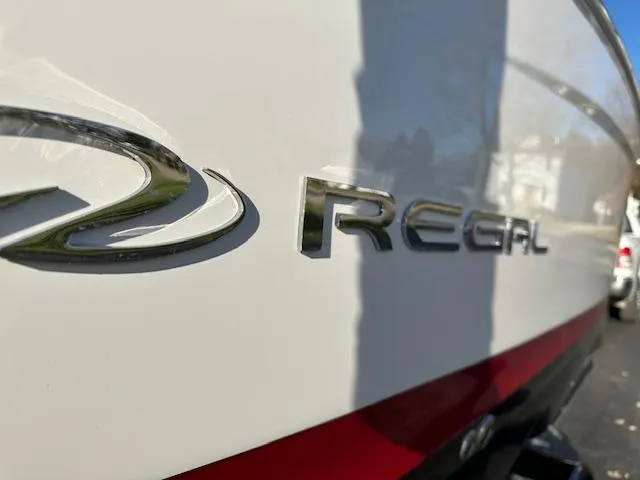Slide: The Image of 2025 Regal LS9 Surf boat logo on sleek white hull. - 43