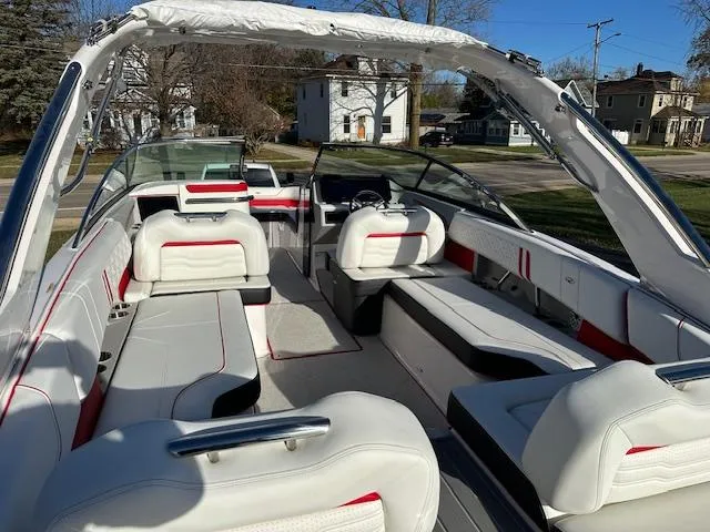 Slide: The Image of 2025 Regal LS9 Surf boat interior with white and red seating, open layout, and sleek design. - 5