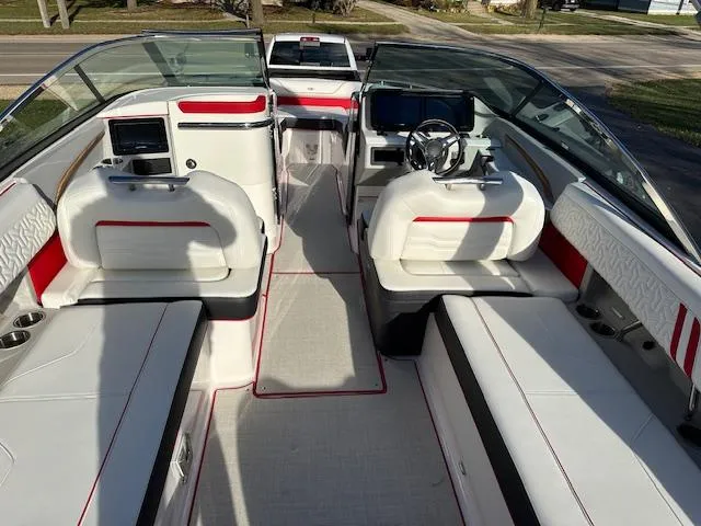 Slide: The Image of 2025 Regal LS9 Surf boat interior with white and red seating, modern dashboard, and spacious layout. - 6