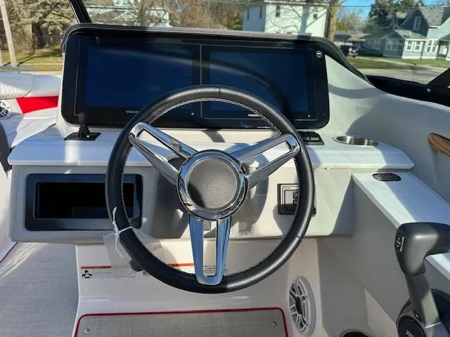 Slide: The Image of 2025 Regal LS9 Surf boat dashboard with steering wheel and digital displays. - 8