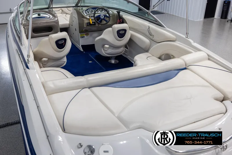 Slide: The Image of 2006 Crownline 230 LS boat interior with white seating and blue accents. - 11