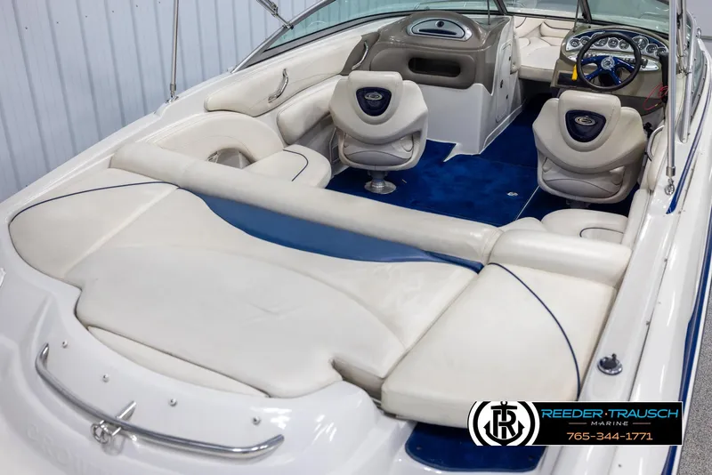 Slide: The Image of 2006 Crownline 230 LS boat interior with white seating and blue carpet. - 12