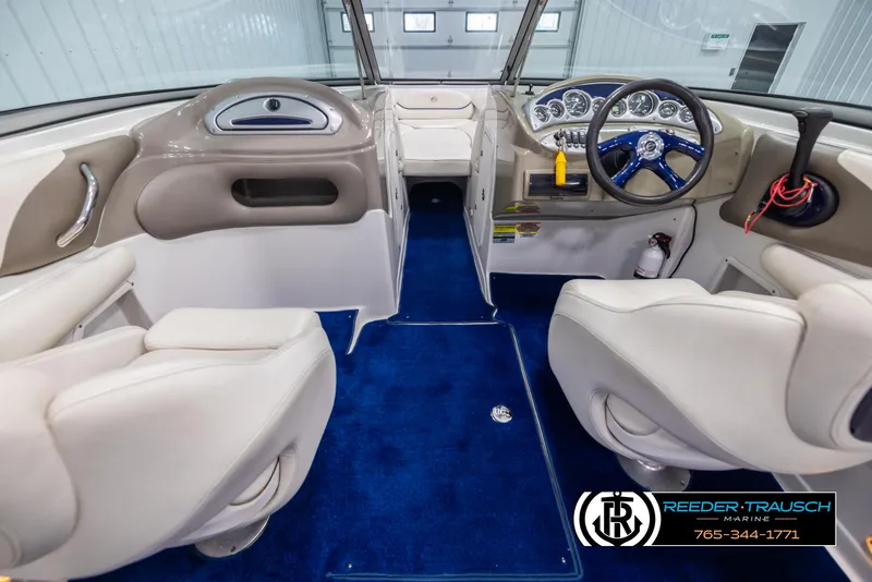 Slide: The Image of Interior of 2006 Crownline 230 LS boat with blue carpet and white seating. - 14