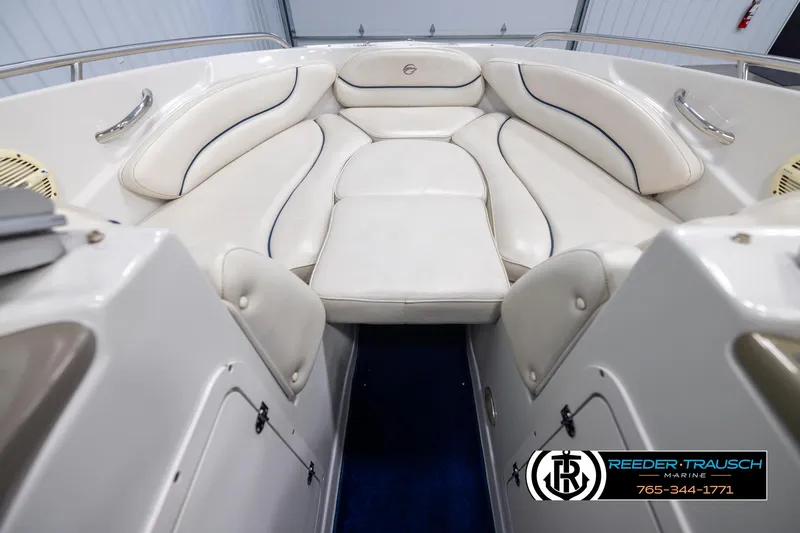 Slide: The Image of 2006 Crownline 230 LS boat interior with white cushioned seating. - 15