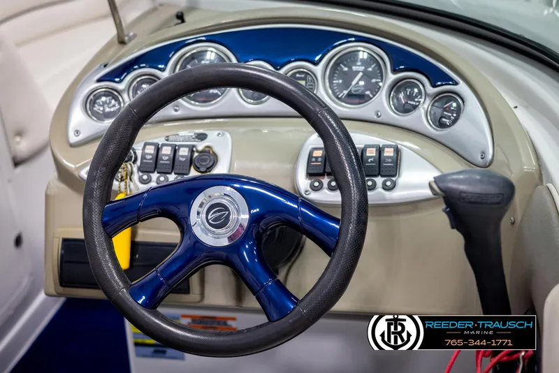 Slide: The Image of Steering wheel and dashboard of a 2006 Crownline 230 LS boat. - 24