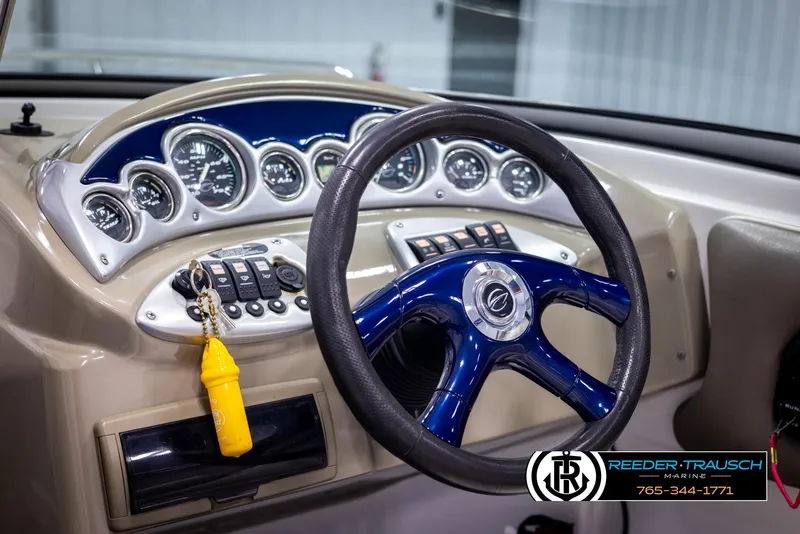 Slide: The Image of 2006 Crownline 230 LS boat dashboard with steering wheel and gauges. - 25